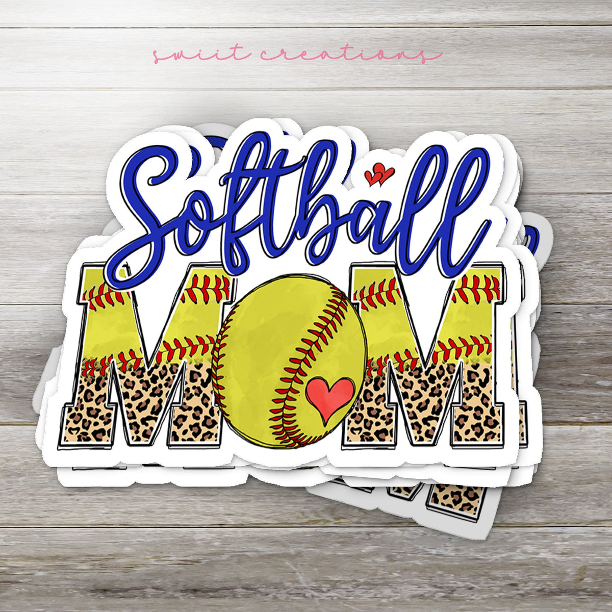 Stack of Softball Mom glossy stickers on a gray wood table