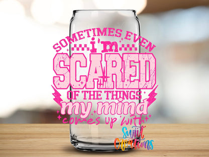 Close-up of the Sometimes Even I'm Scared pink letters UV DTF transfer on a clear glass can