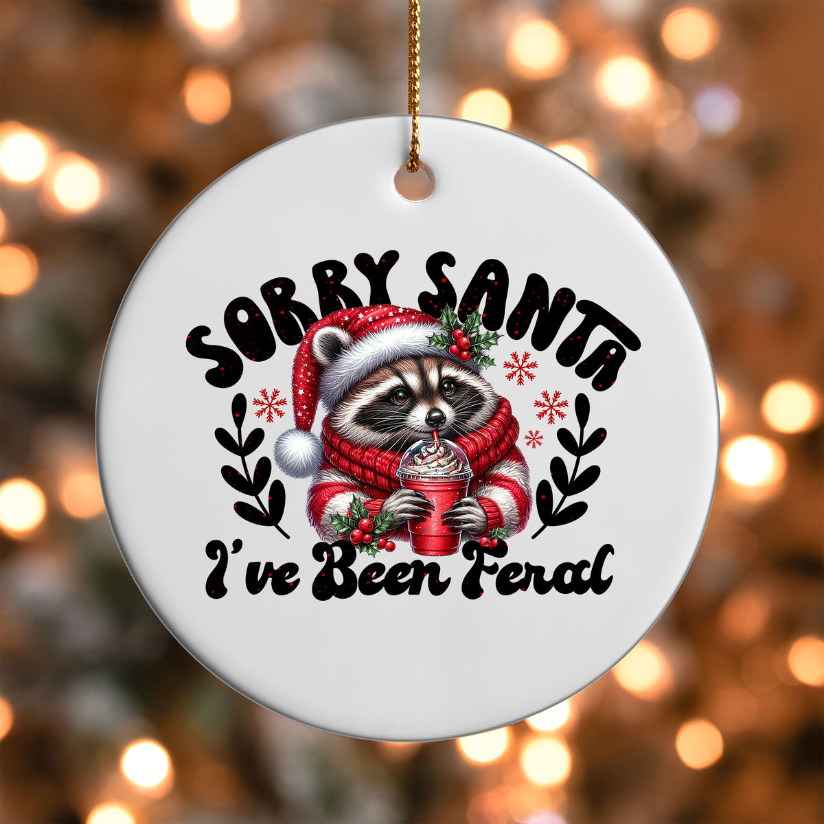 Sorry Santa I've Been Feral ornament UV DTF transfer on a round white ornament with a bokeh light background