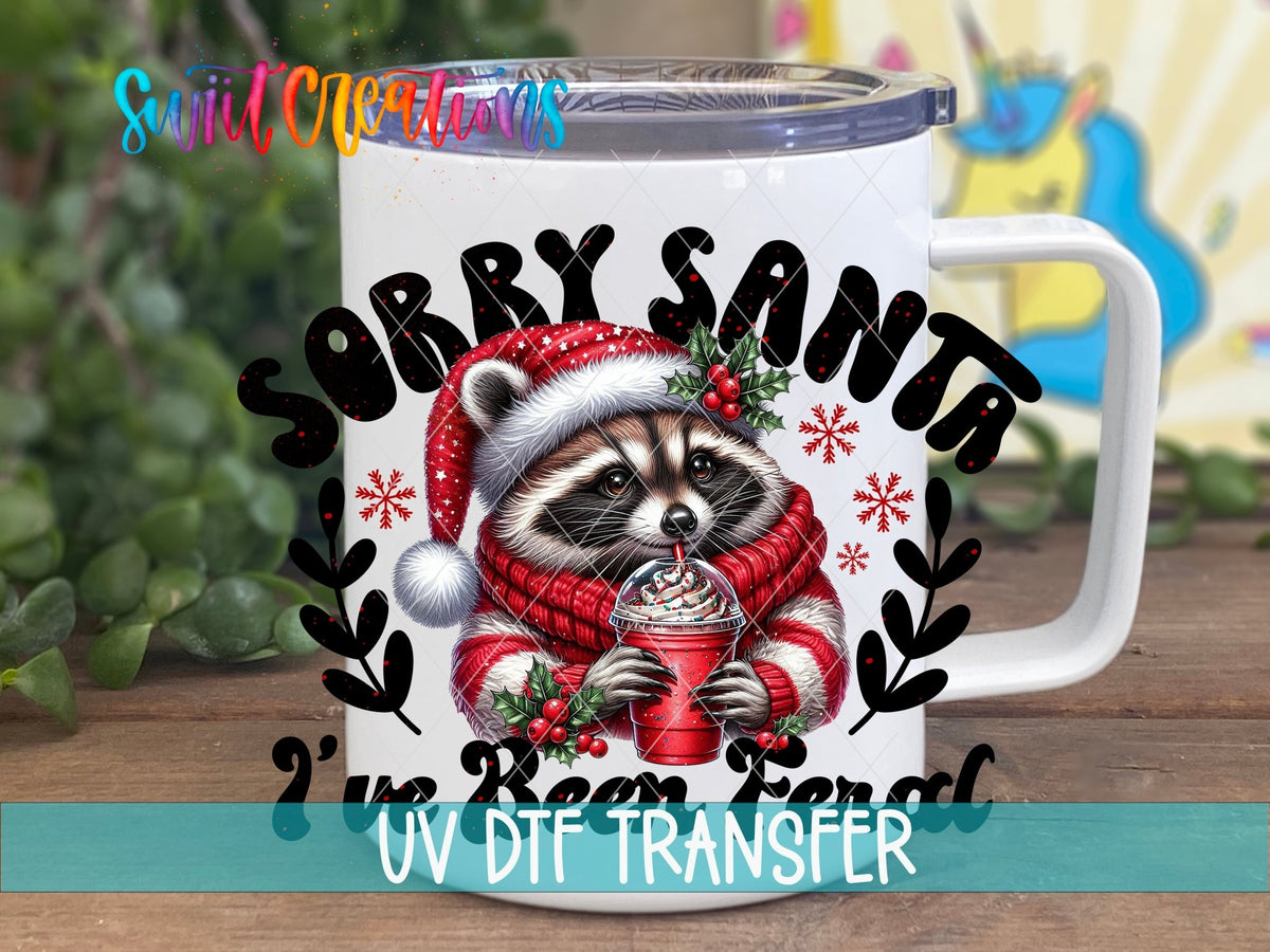 Sorry Santa I've Been Feral raccoon in a red sweater UV DTF transfer on a white stainless steel mug with a lid