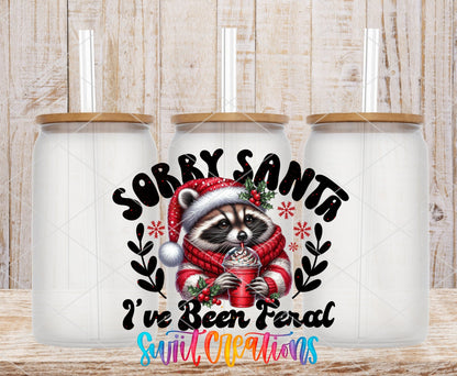 Sorry Santa I've Been Feral raccoon in a red sweater UV DTF transfer on frosted glass cans with bamboo lids