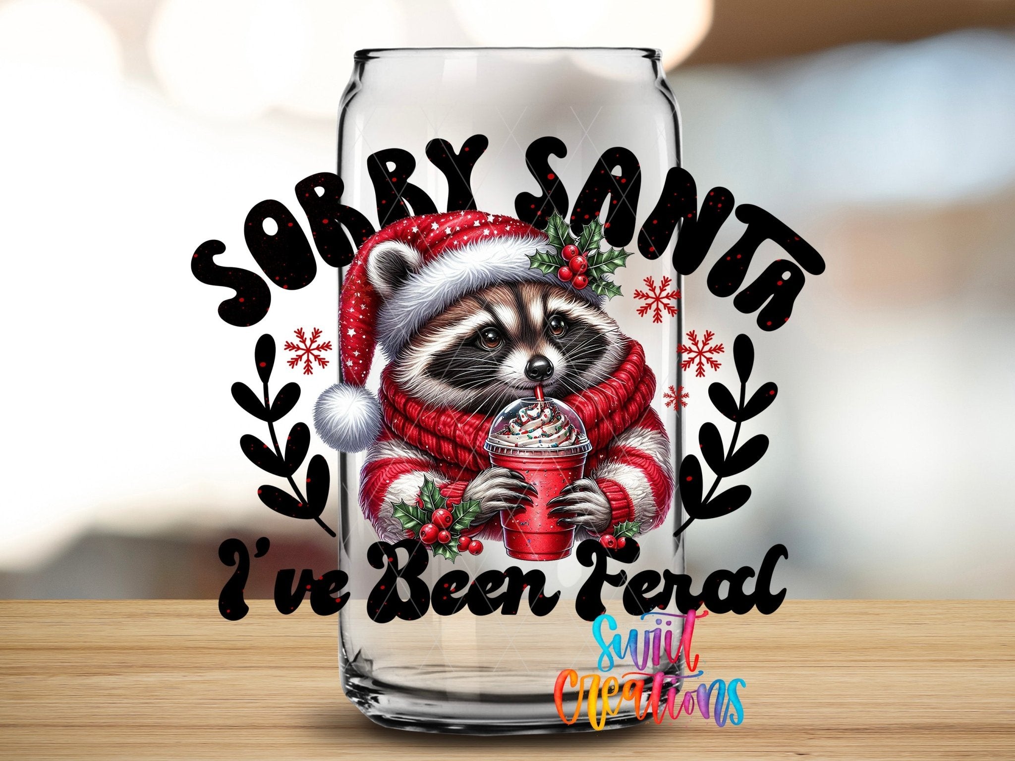 Swiit Creations UV DTF Feral Raccoon Christmas transfer applied to a clear glass can