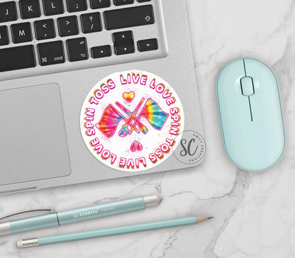 Spin Toss Live Love vinyl sticker on a silver laptop next to a mint mouse and pens