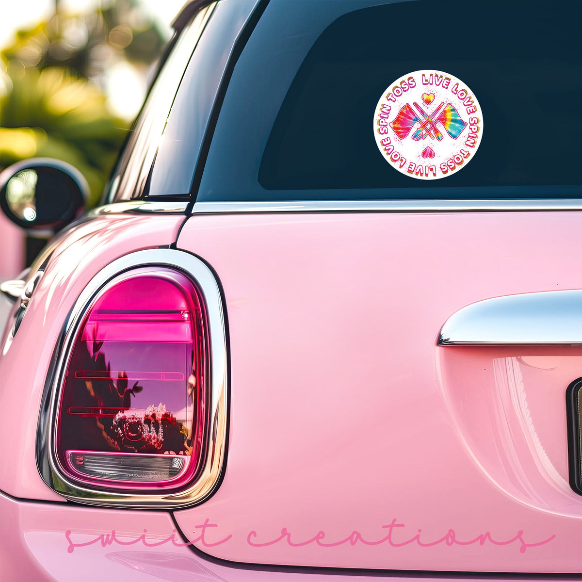 Spin Toss Live Love sticker on the back window of a pink car