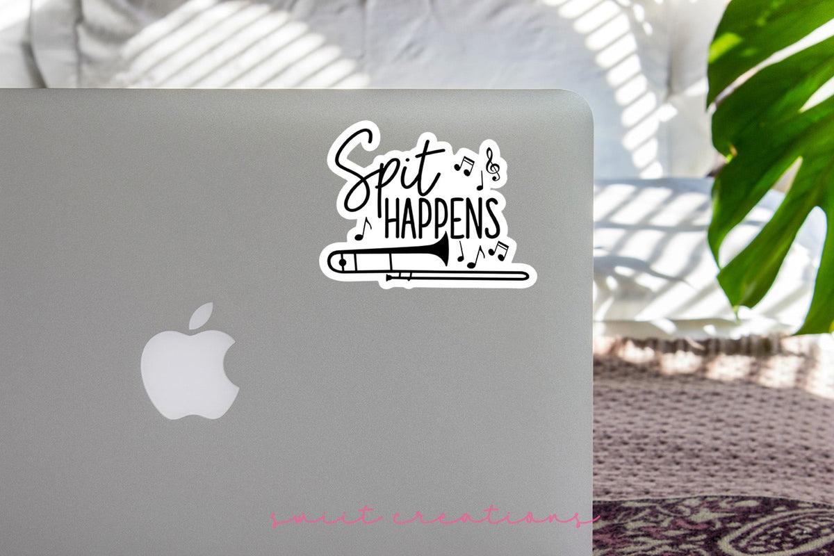 Spit Happens sticker on the lid of a silver laptop