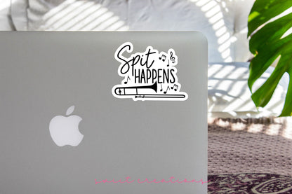 Spit Happens sticker on the lid of a silver laptop