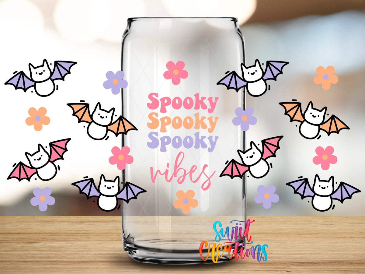 Close-up of the Spooky Vibes pastel bats and daisies UV DTF full wrap on a clear glass can