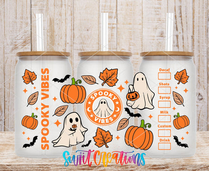 Spooky Vibes ghost coffee badge and pumpkins UV DTF wrap on three clear glass cans with bamboo lids