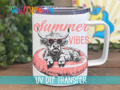 Summer Vibes highland cow on a pink float UV DTF transfer on a white stainless steel mug with a lid