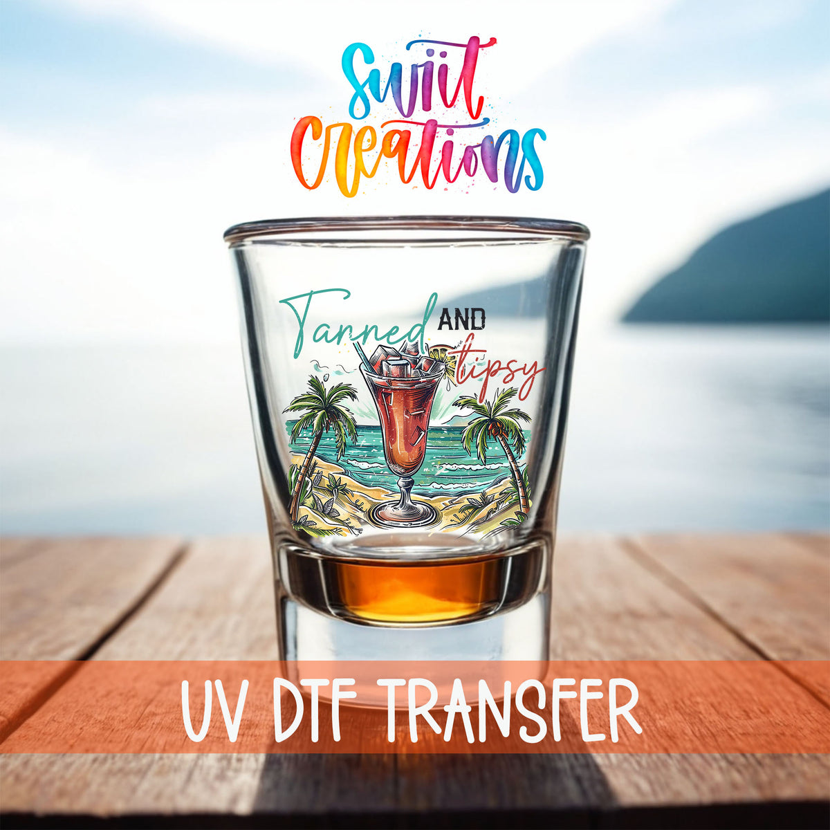 Tanned and Tipsy shot glass UV DTF transfer on a filled shot glass on a dock by the water