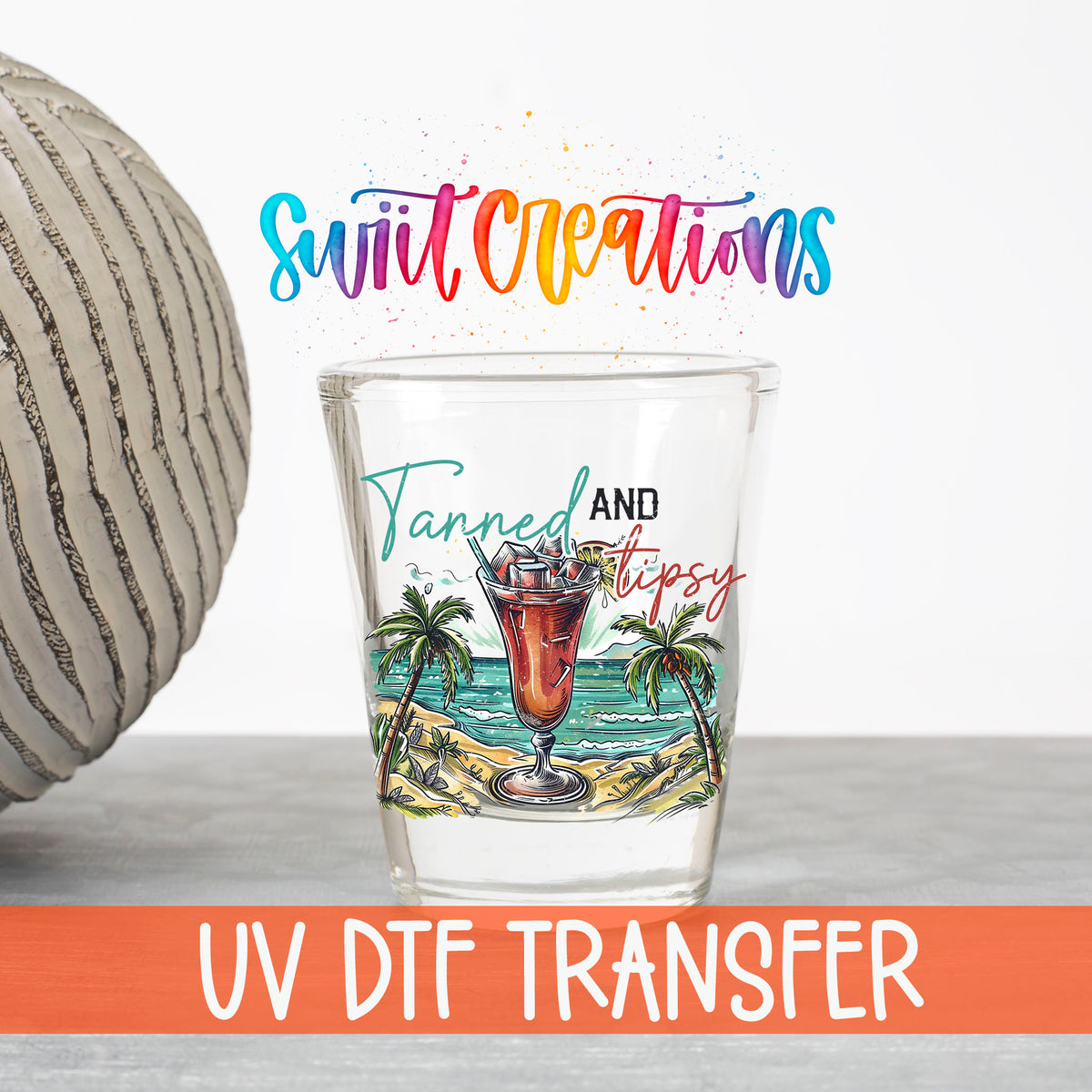 Tanned and Tipsy UV DTF transfer on a clear shot glass with the Swiit Creations logo and UV DTF Transfer banner