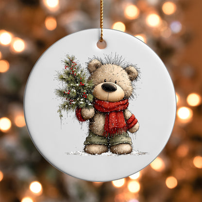 Teddy Bear with Pine Branch ornament UV DTF transfer on a round white ornament with a bokeh light background