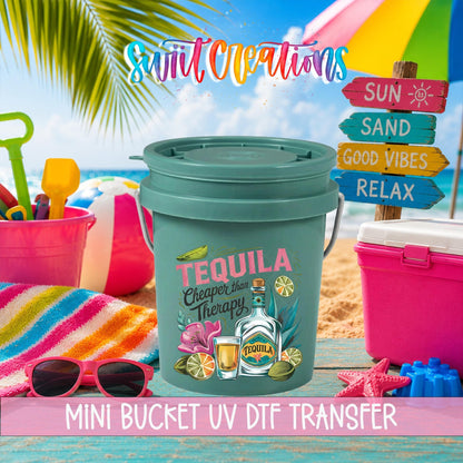 Tequila Cheaper Than Therapy UV DTF transfer on a teal mini bucket in a beach scene with a Mini Bucket UV DTF Transfer banner