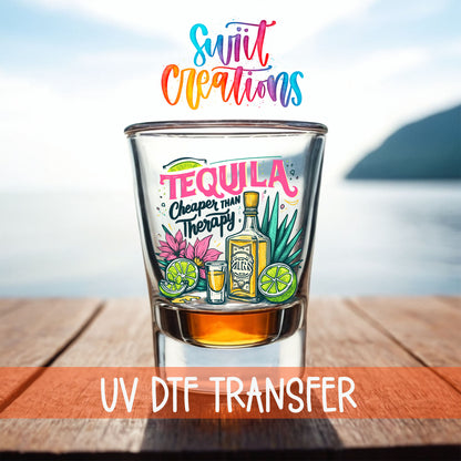 Tequila Cheaper Than Therapy shot glass UV DTF transfer on a filled shot glass on a dock by the water