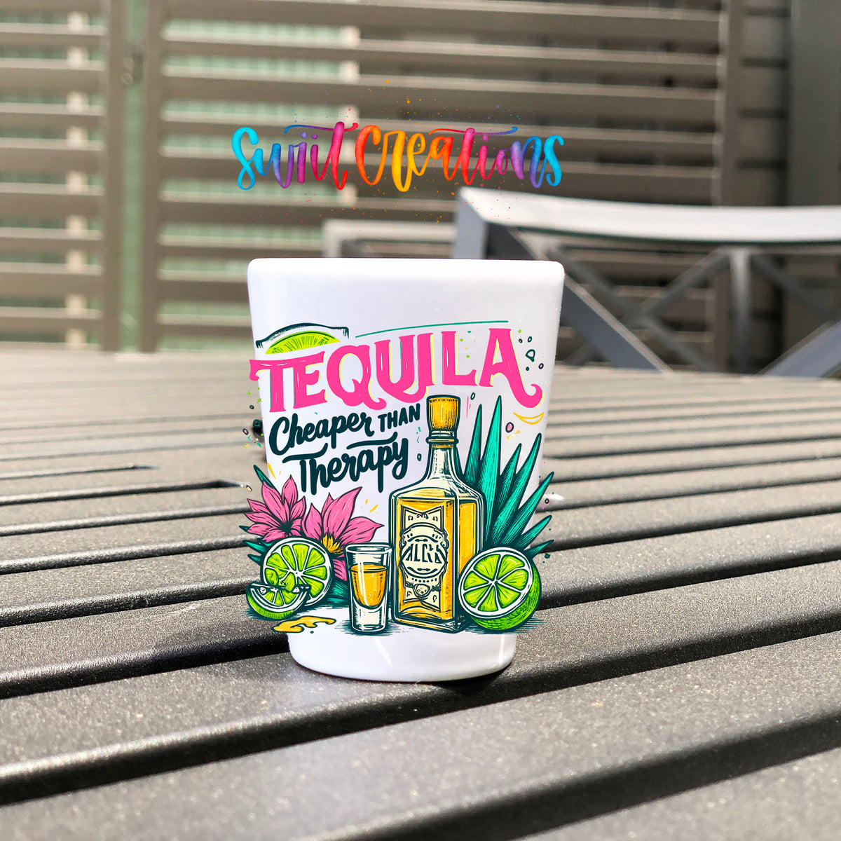 Tequila Cheaper Than Therapy UV DTF transfer on a white shot glass on an outdoor patio table