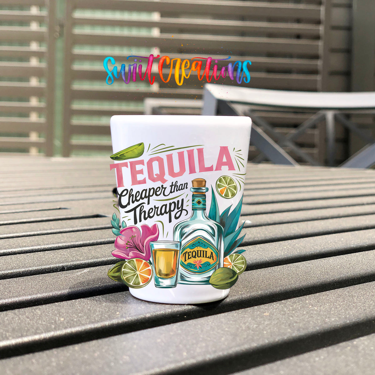 Tequila Cheaper Than Therapy UV DTF transfer on a white shot glass on an outdoor patio table