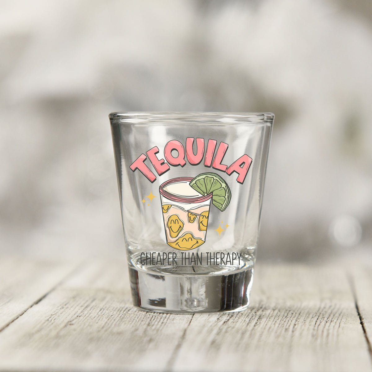 Close-up of the Tequila Cheaper Than Therapy UV DTF transfer on a clear shot glass