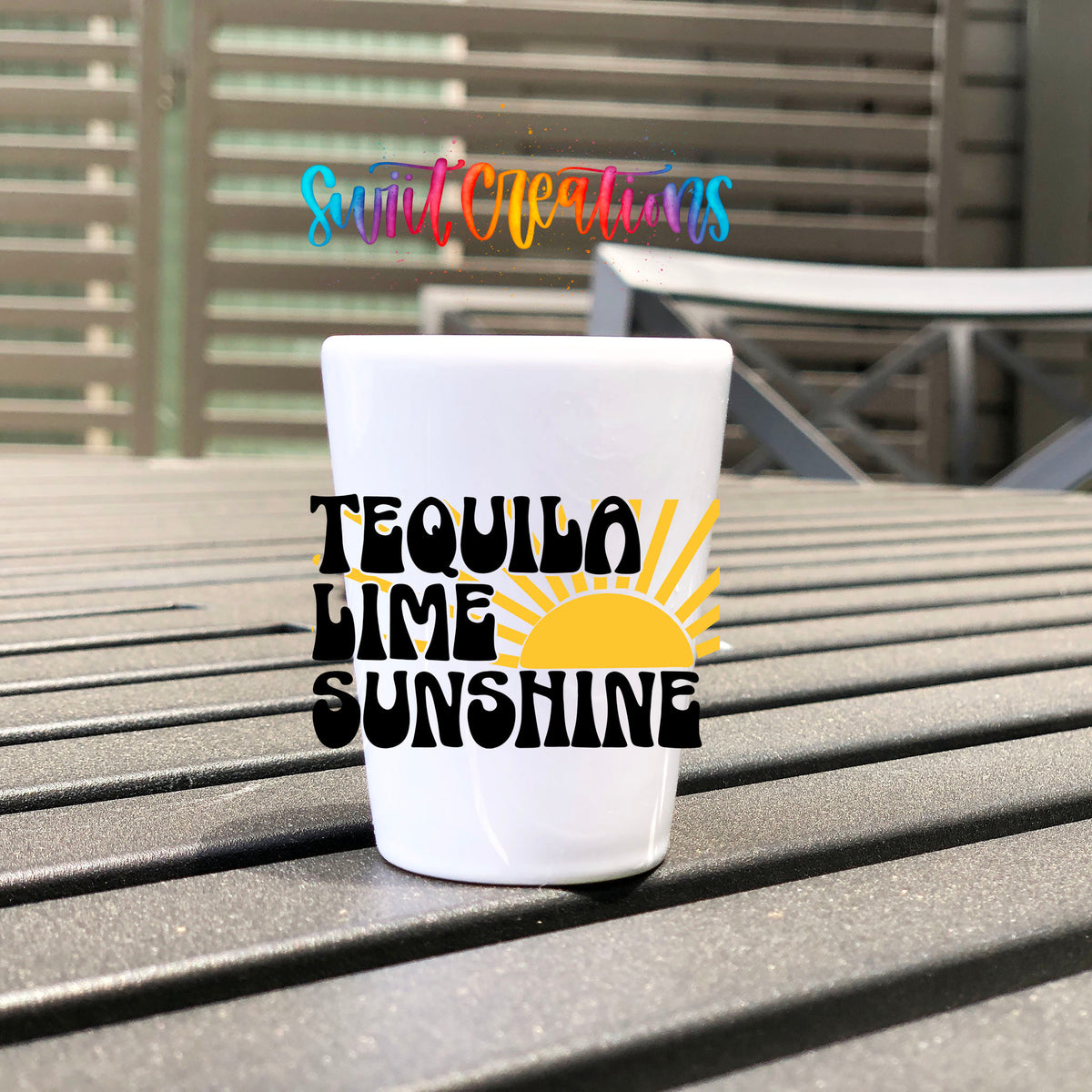 Tequila Lime Sunshine UV DTF transfer on a white shot glass on an outdoor patio table
