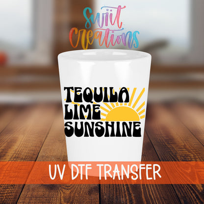 Tequila Lime Sunshine shot glass transfer on a white shot glass on a wooden table