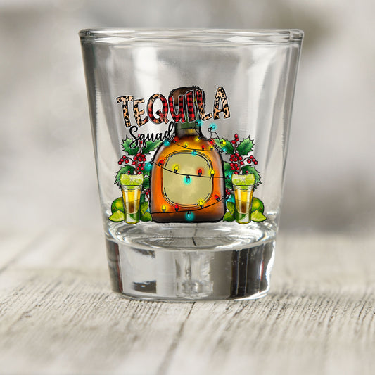 Tequila Squad shot glass UV DTF transfer with tequila bottle with Christmas lights and holly on a clear shot glass