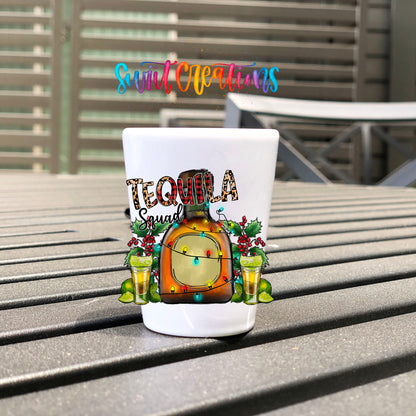 Tequila Squad UV DTF transfer on a white shot glass on an outdoor patio table