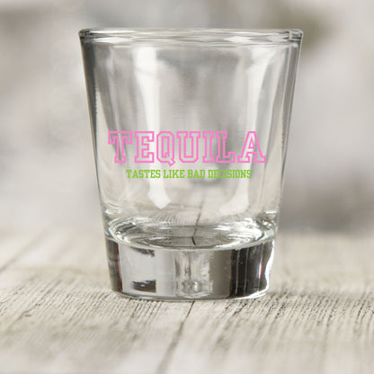 Tequila Tastes Like Bad Decisions shot glass UV DTF transfer with pink varsity-style lettering on a clear shot glass