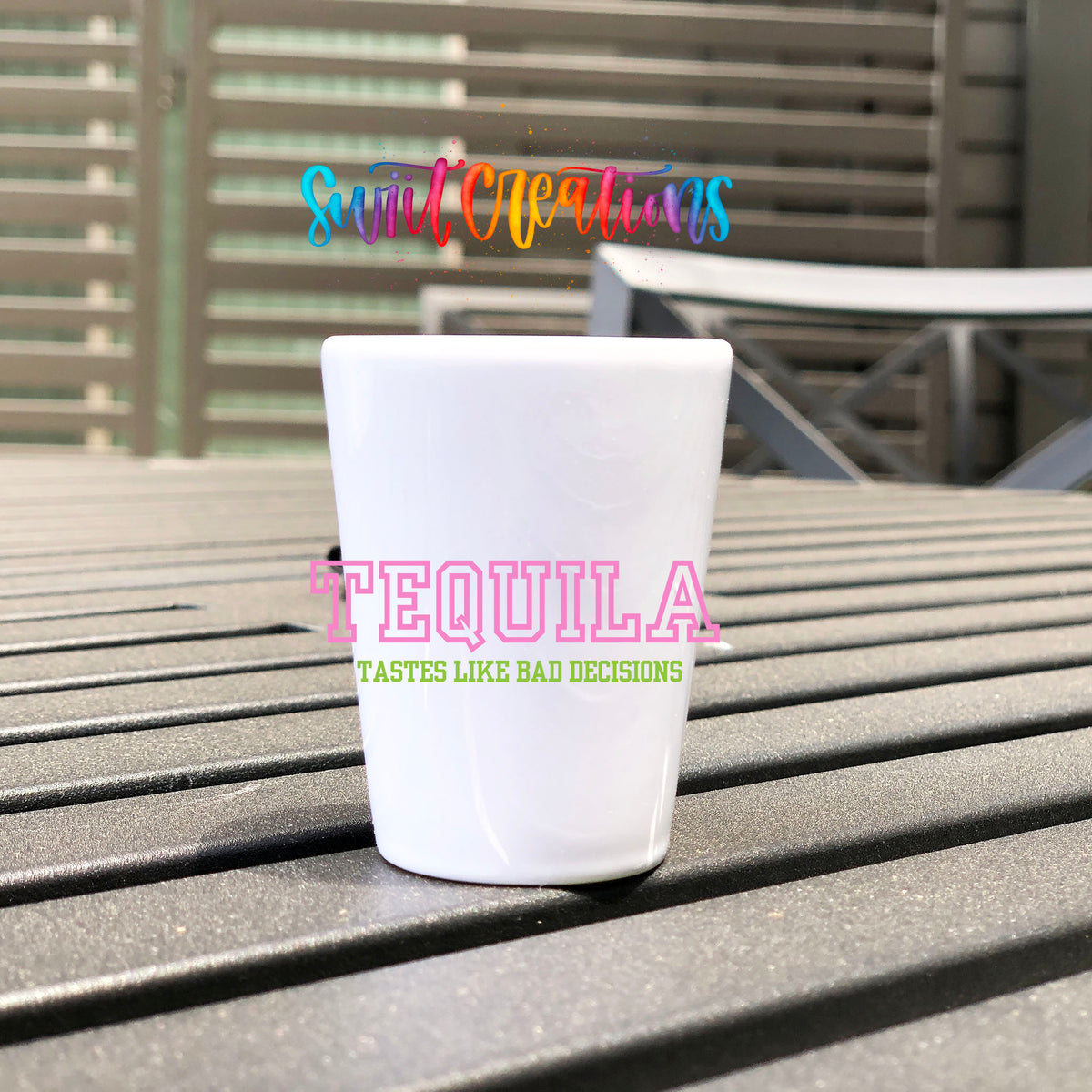 Tequila Tastes Like Bad Decisions UV DTF transfer on a white shot glass on an outdoor patio table