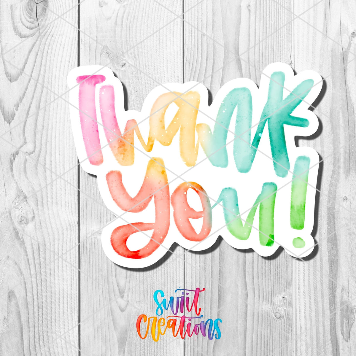 Watercolor Rainbow Thank You sticker close-up on white wood