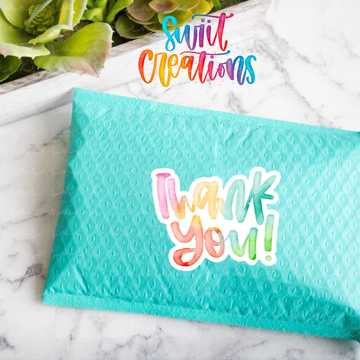 Watercolor Rainbow Thank You sticker on a teal poly mailer