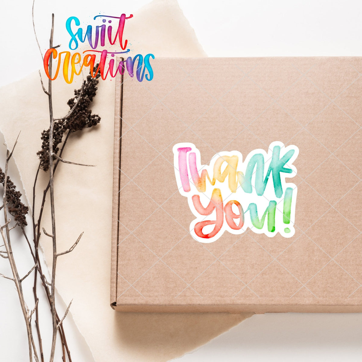 Watercolor Rainbow Thank You sticker on a kraft shipping box