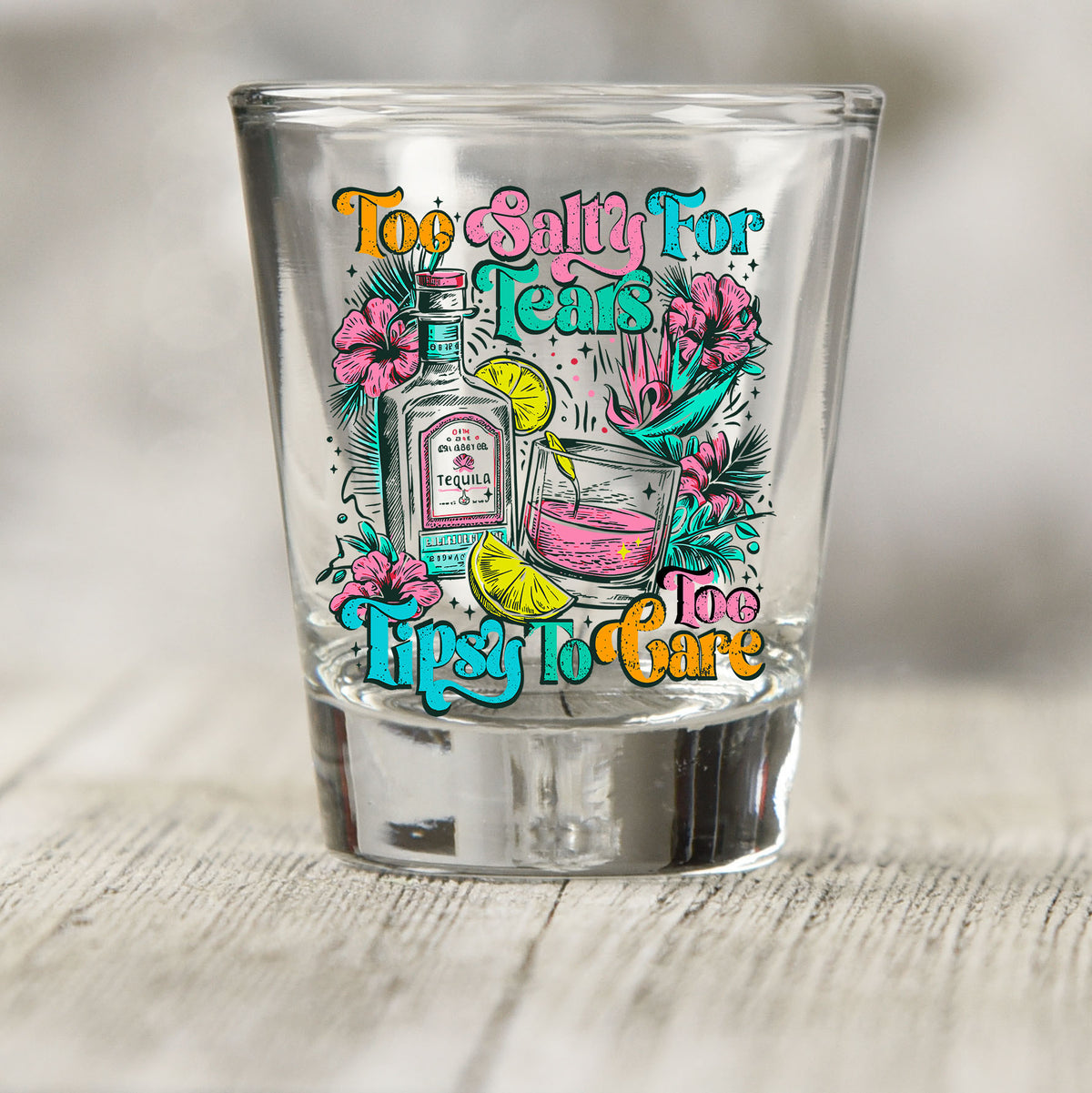 Too Salty For Tears Too Tipsy To Care shot glass UV DTF transfer with tequila bottle, cocktail, citrus, and hibiscus details on a clear shot glass