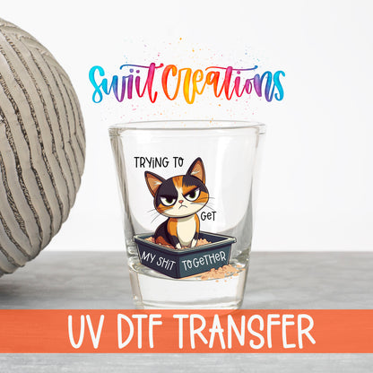 Trying to Get My Sh*t Together UV DTF transfer on a clear shot glass with the Swiit Creations logo and UV DTF Transfer banner