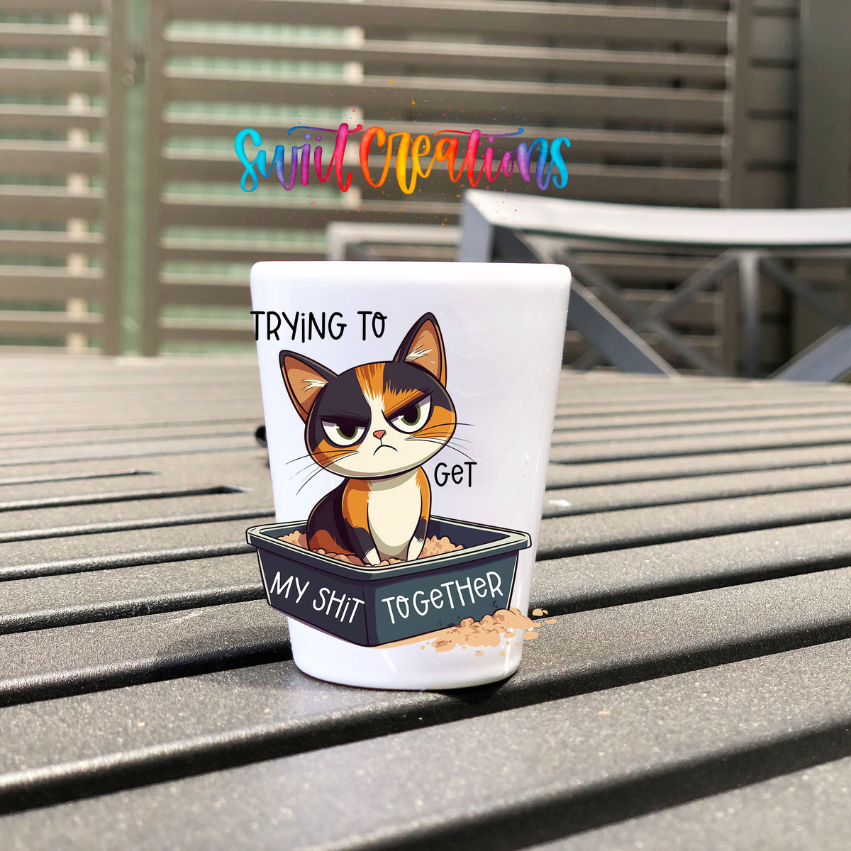 Trying to Get My Sh*t Together UV DTF transfer on a white shot glass on an outdoor patio table