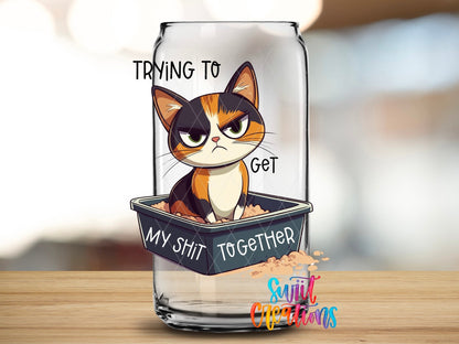 Close-up of the Trying to Get My Sh*t Together calico cat UV DTF transfer on a clear glass can