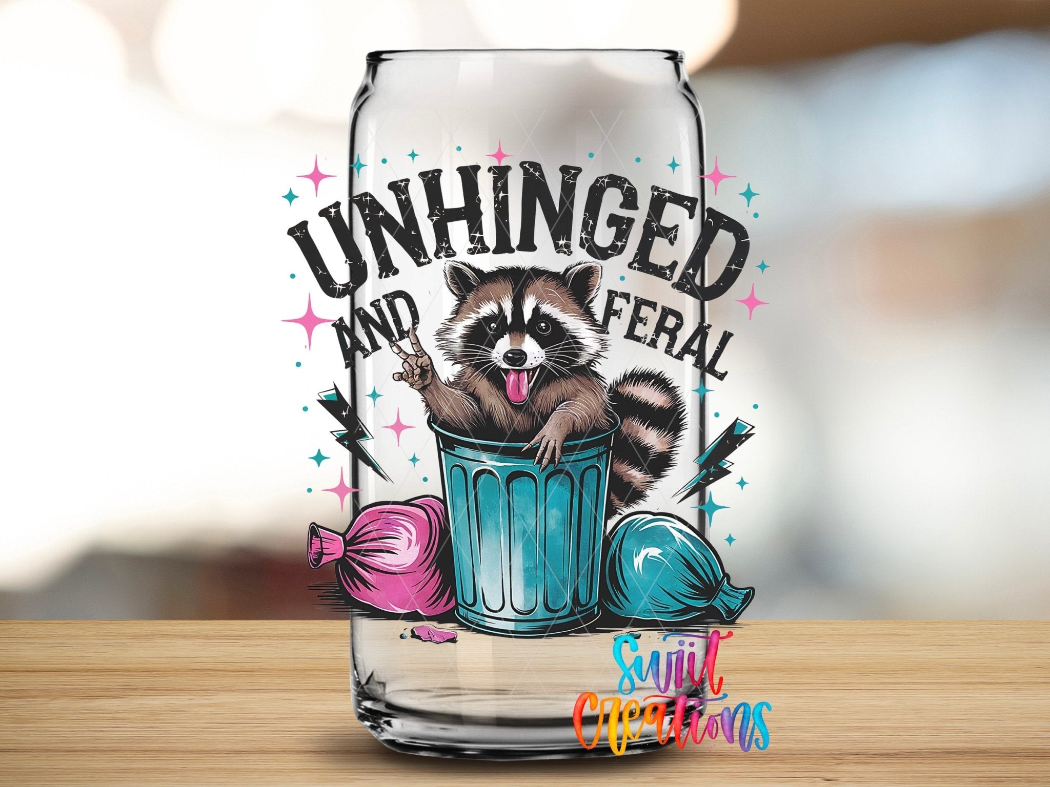Unhinged and Feral Sassy Raccoon UV DTF transfer applied to a clear glass can from Swiit Creations