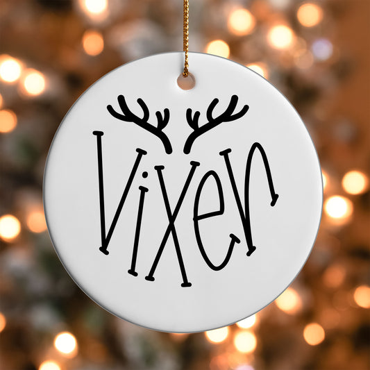 Vixen Reindeer Name ornament UV DTF transfer on a round white ornament with a bokeh light background