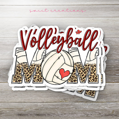 Stack of Volleyball Mom glossy stickers on a gray wood table