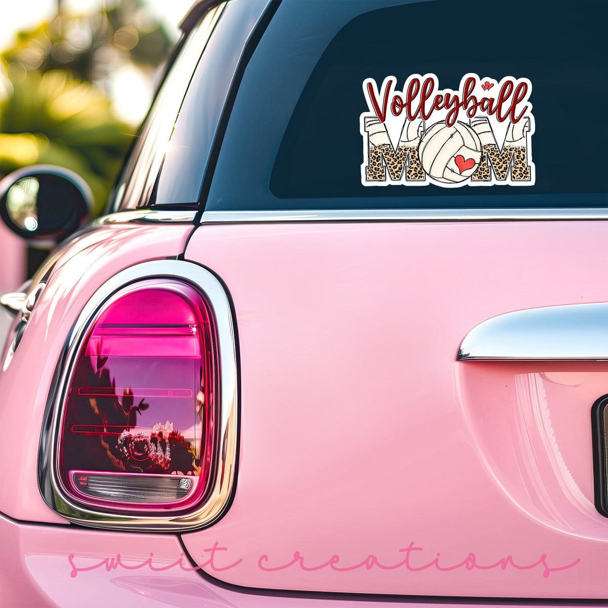 Volleyball Mom sticker on the back window of a pink car