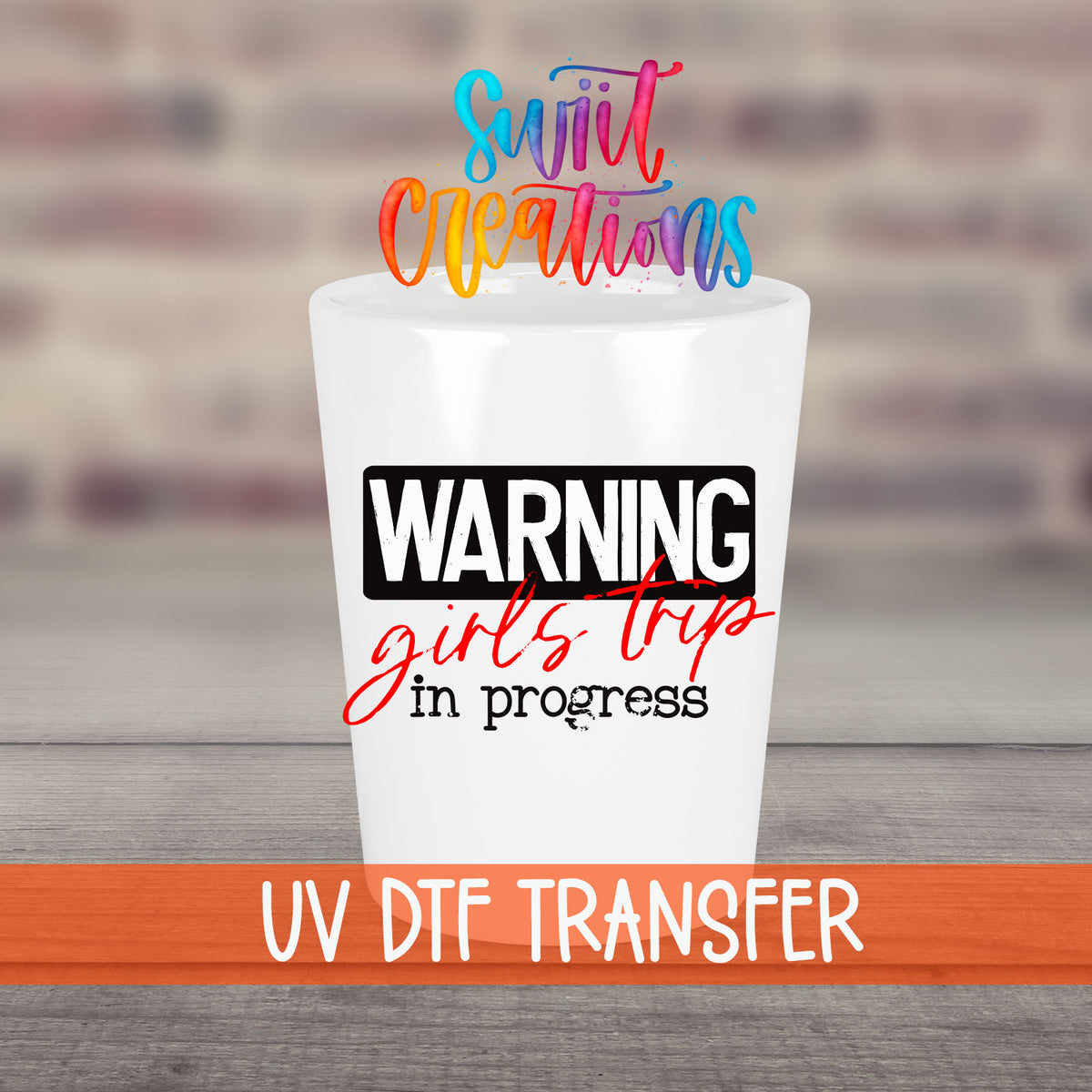 Warning Girls Trip in Progress UV DTF transfer on a white shot glass in front of a brick wall