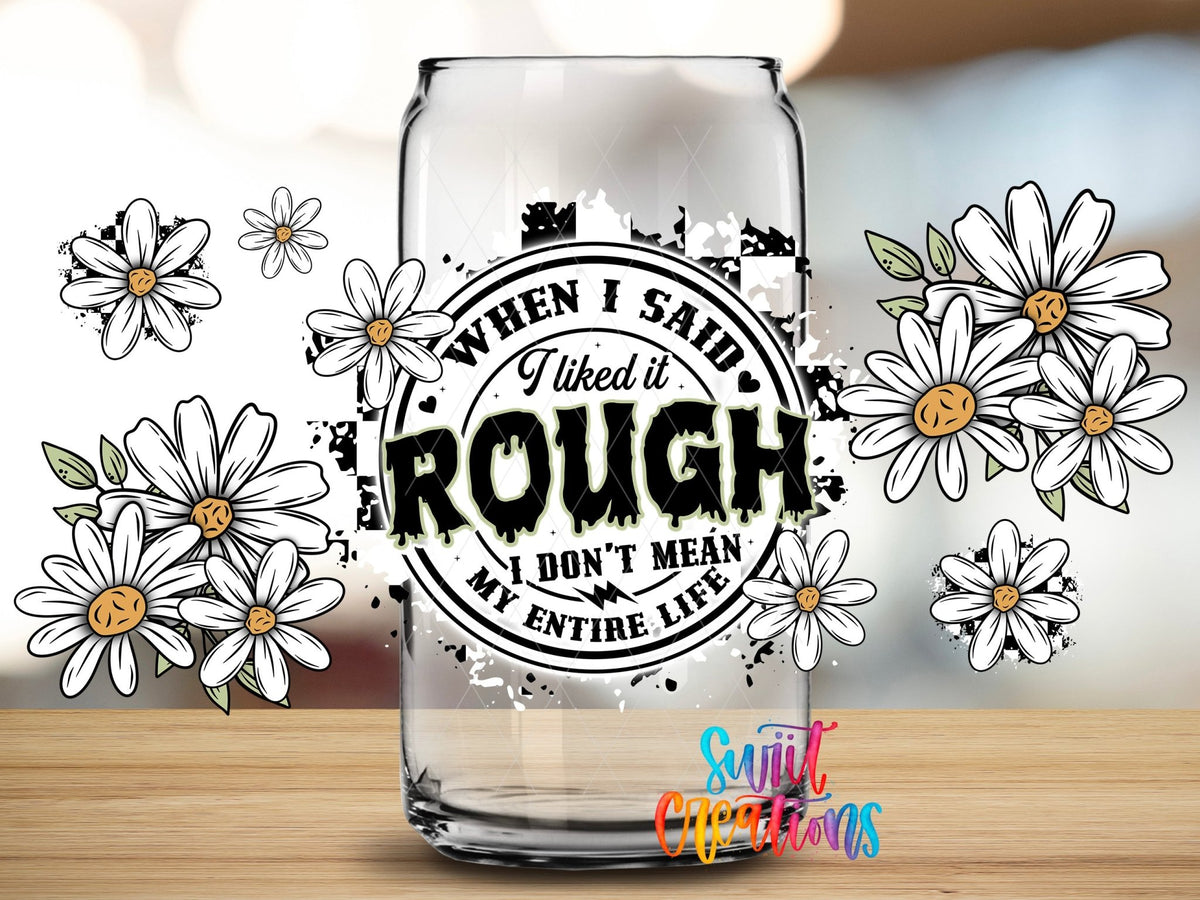 Close-up of the When I Said I Liked It Rough daisies and stamp UV DTF full wrap on a clear glass can