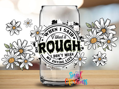 Close-up of the When I Said I Liked It Rough daisies and stamp UV DTF full wrap on a clear glass can
