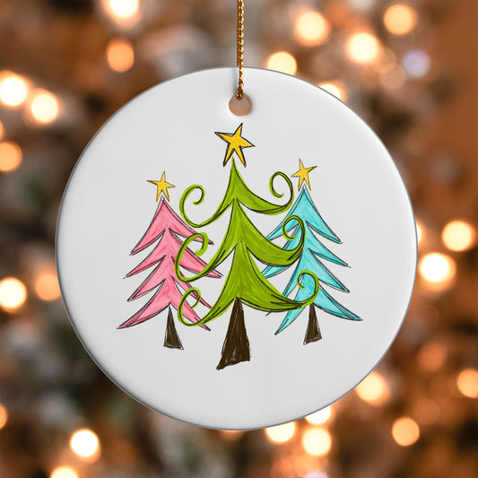 Whimsical Christmas Trees ornament UV DTF transfer on a round white ornament with a bokeh light background