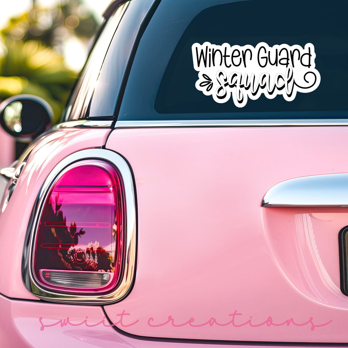 Winter Guard Squad sticker on the back window of a pink car
