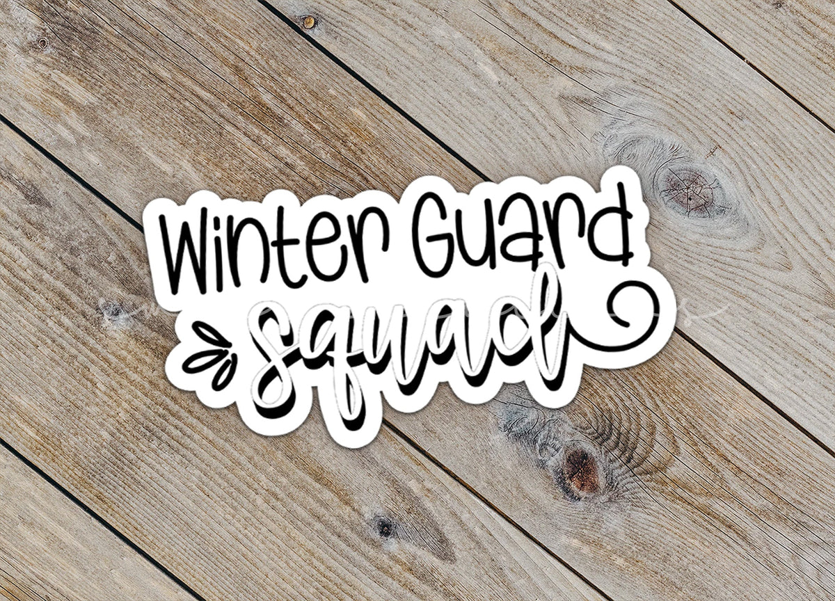 Close-up of the Winter Guard Squad sticker on rustic wood