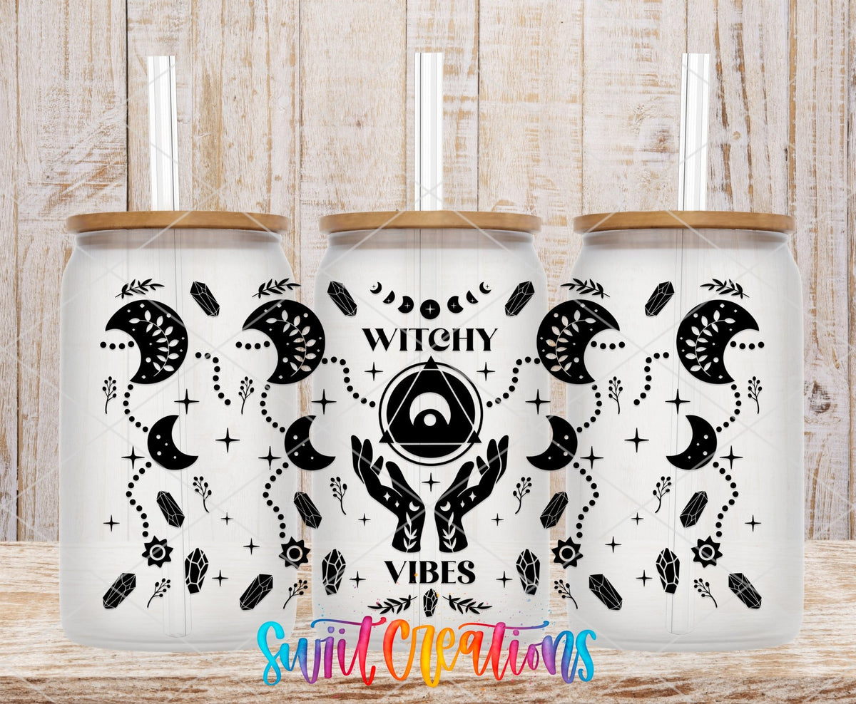 Witchy Vibes UV DTF wrap on three clear glass cans with bamboo lids