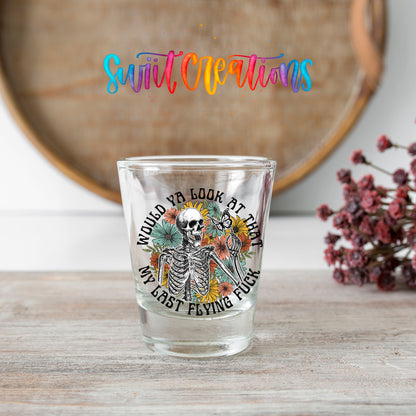 Would You Look At That My Last Flying F*ck shot glass transfer on a clear glass beside a wooden barrel and dried flowers