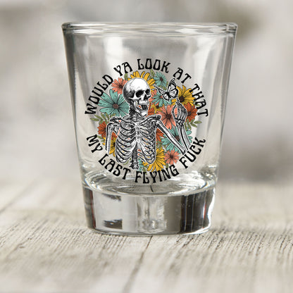 Would You Look At That My Last Flying F*ck shot glass UV DTF transfer with skeleton, butterfly, and wildflowers on a clear shot glass