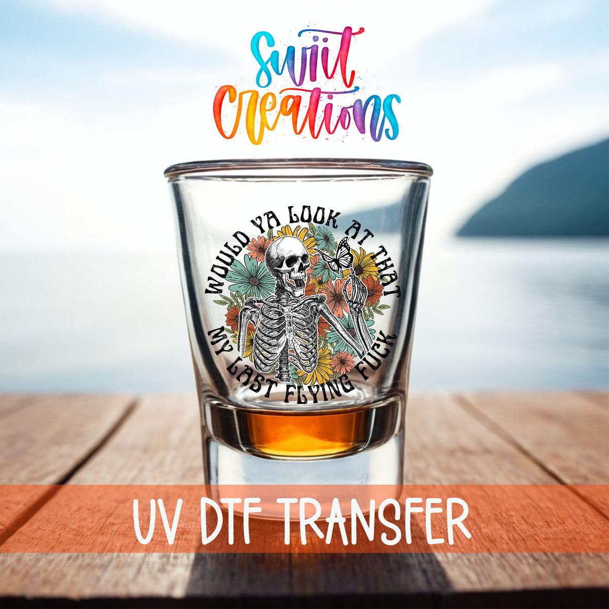 Would You Look At That My Last Flying F*ck shot glass UV DTF transfer on a filled shot glass on a dock by the water