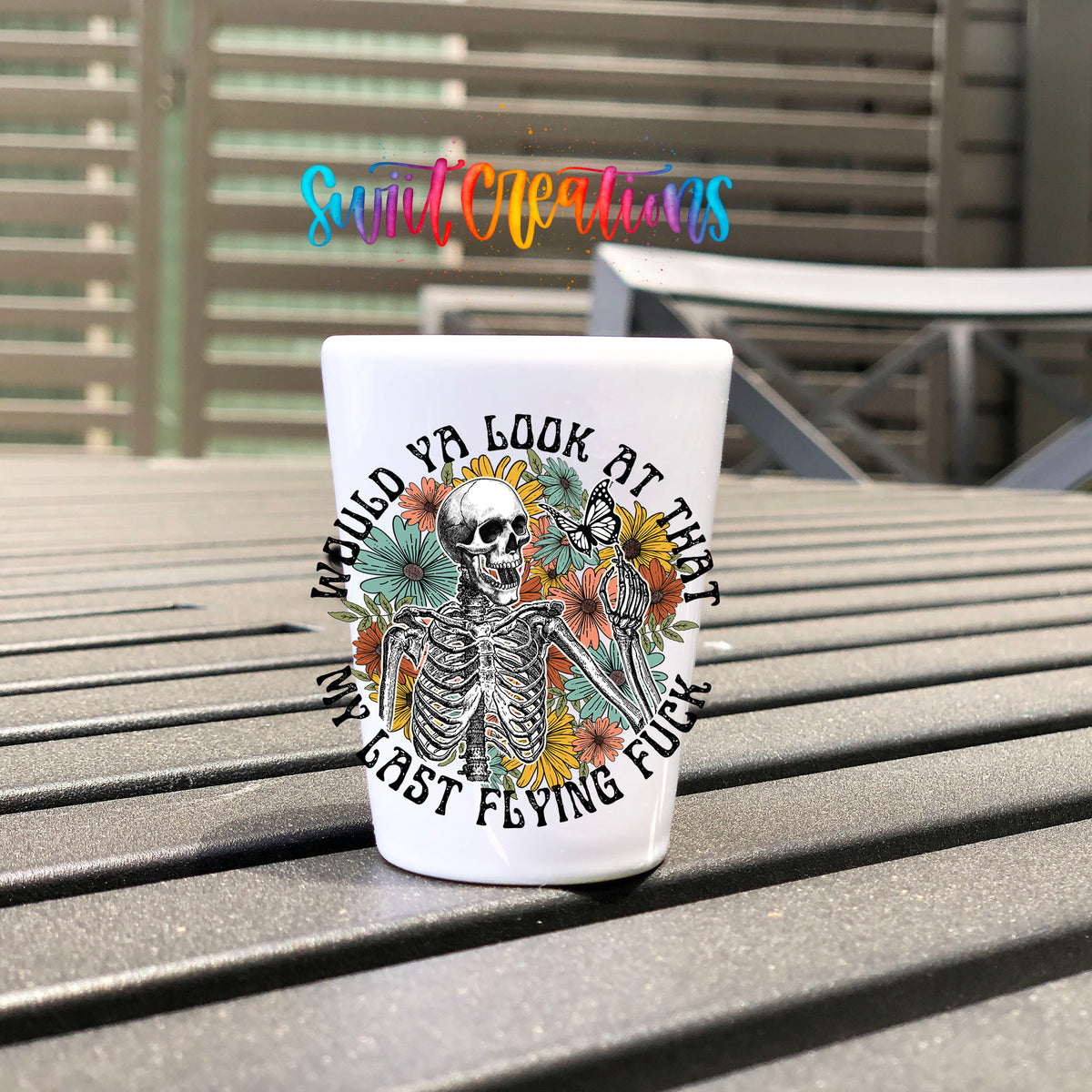 Would You Look At That My Last Flying F*ck UV DTF transfer on a white shot glass on an outdoor patio table