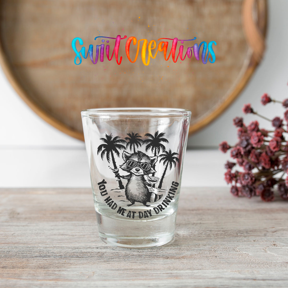 You Had Me at Day Drinking shot glass transfer on a clear glass beside a wooden barrel and dried flowers